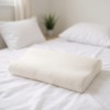 Un coussin de confort anti-fatigue pour le lit dans la chambre